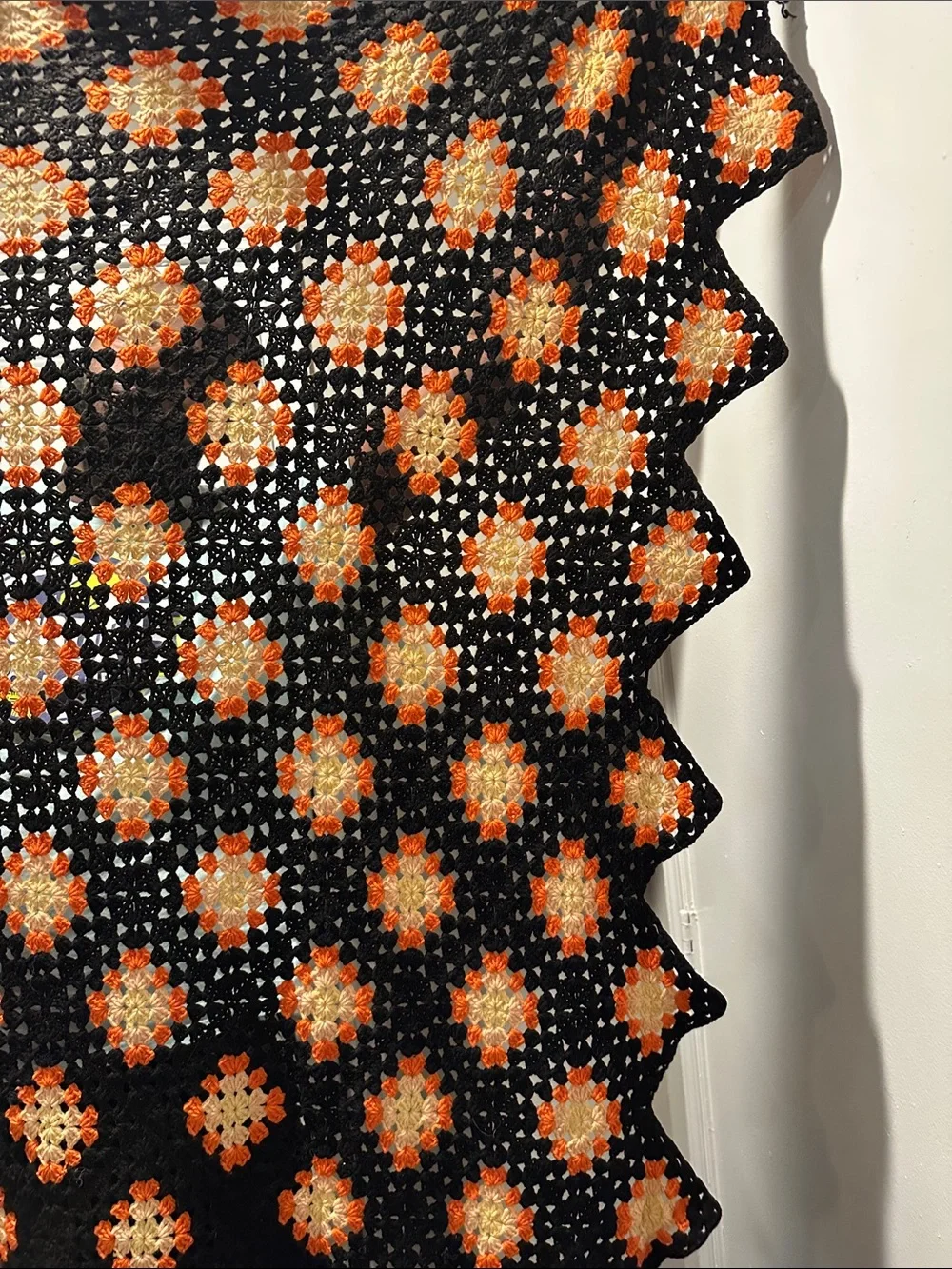 Granny Square black with orange crochet blanket with zig zag hem